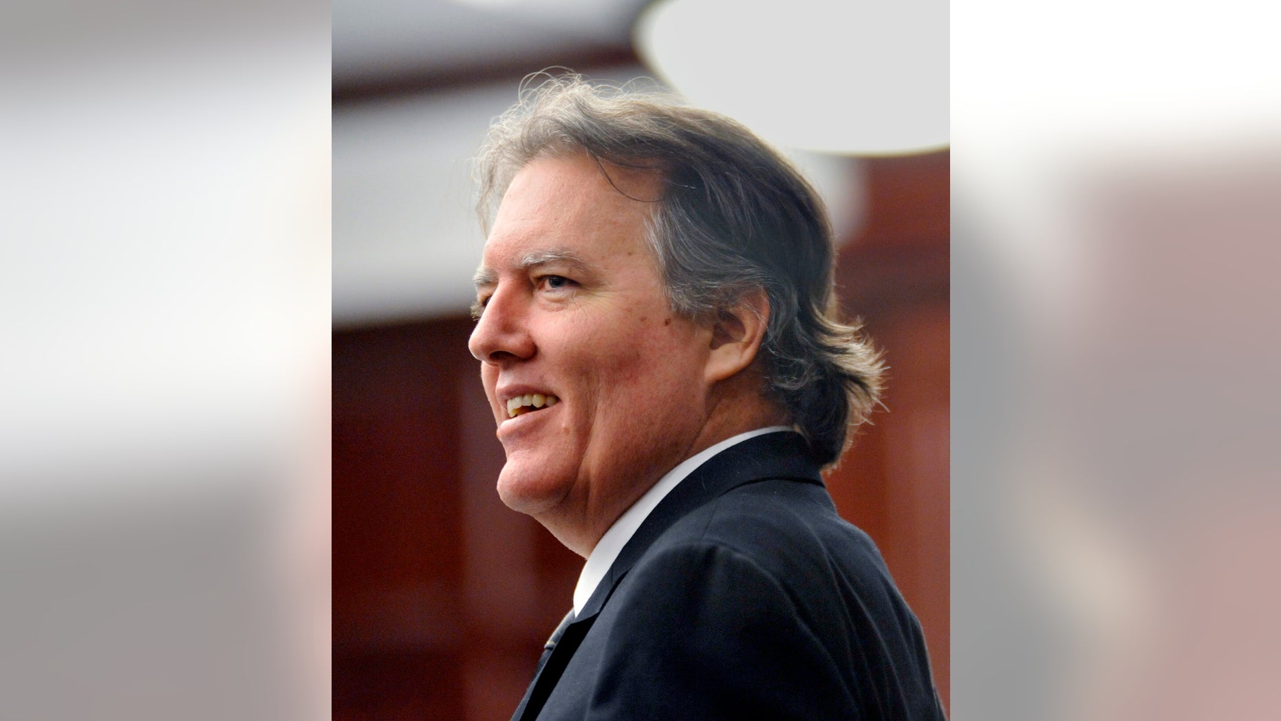 FILE - In this March 19, 2013 file photo, Michael David Dunn smiles at family and friends who came to testify at his bond hearing in Jacksonville, Fla. Dunn is about to go on trial for the alleged murder of a black teenager in a case that raises comparisons to the George Zimmerman-Trayvon Martin case. Jury selection is scheduled to begin Monday, Feb. 4, 2013, in Jaacksonville, Fla. He fatally shot 17-year-old Jordan Davis in November 2012 outside a convenience store following an argument over loud music Davis and his friends were playing from their SUV. (AP Photo/The Florida Times-Union, Will Dickey, File)