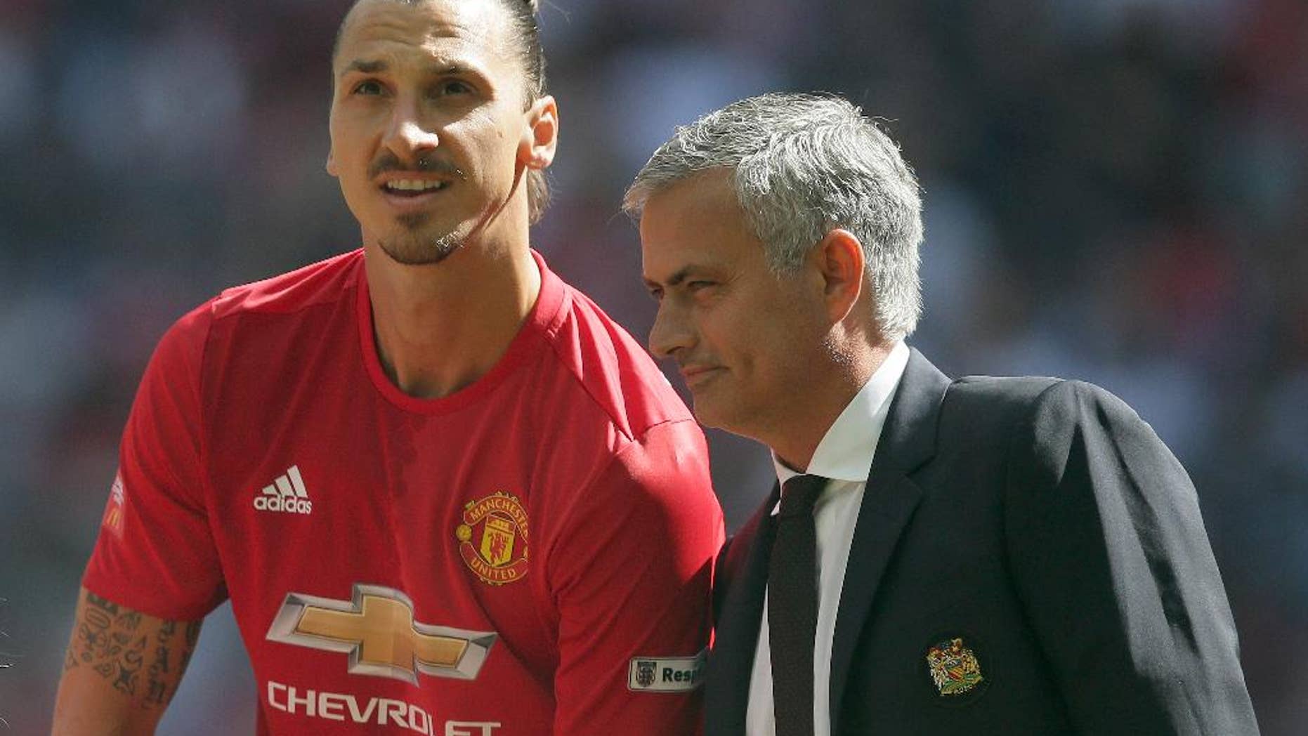 Manchester United manager Jose Mourinho, right, with Manchester United's Zlatan Ibrahimovic during the Community Shield soccer match between Leicester and Manchester United at Wembley stadium in London, Saturday April 9, 2016. (AP Photo/Tim Ireland)