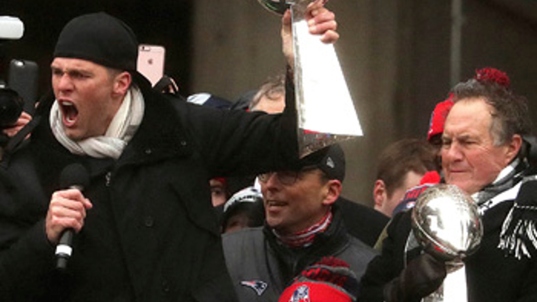 New England Patriots quarterback Tom Brady and head coach Bill Belichick hold Super Bowl trophies during a rally Tuesday, Feb. 7, 2017, in Boston to celebrate Sunday's 34-28 win over the Atlanta Falcons in the NFL Super Bowl 51 football game in Houston. (Barry Chin /The Boston Globe via AP, Pool)