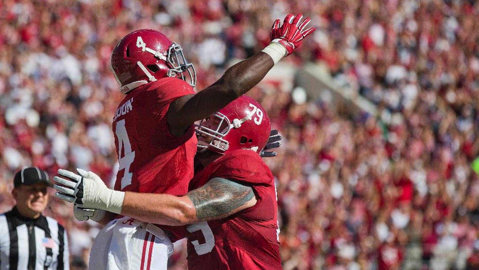 Alabama running back T.J. Yeldon (4) and offensive lineman Austin Shepherd (79) celebrate Yeldon's touchdown during the first half of an NCAA college football game against Texas A&M, Saturday, Oct, 18, 2014, in Tuscaloosa, Ala. (AP Photo/Brynn Anderson)