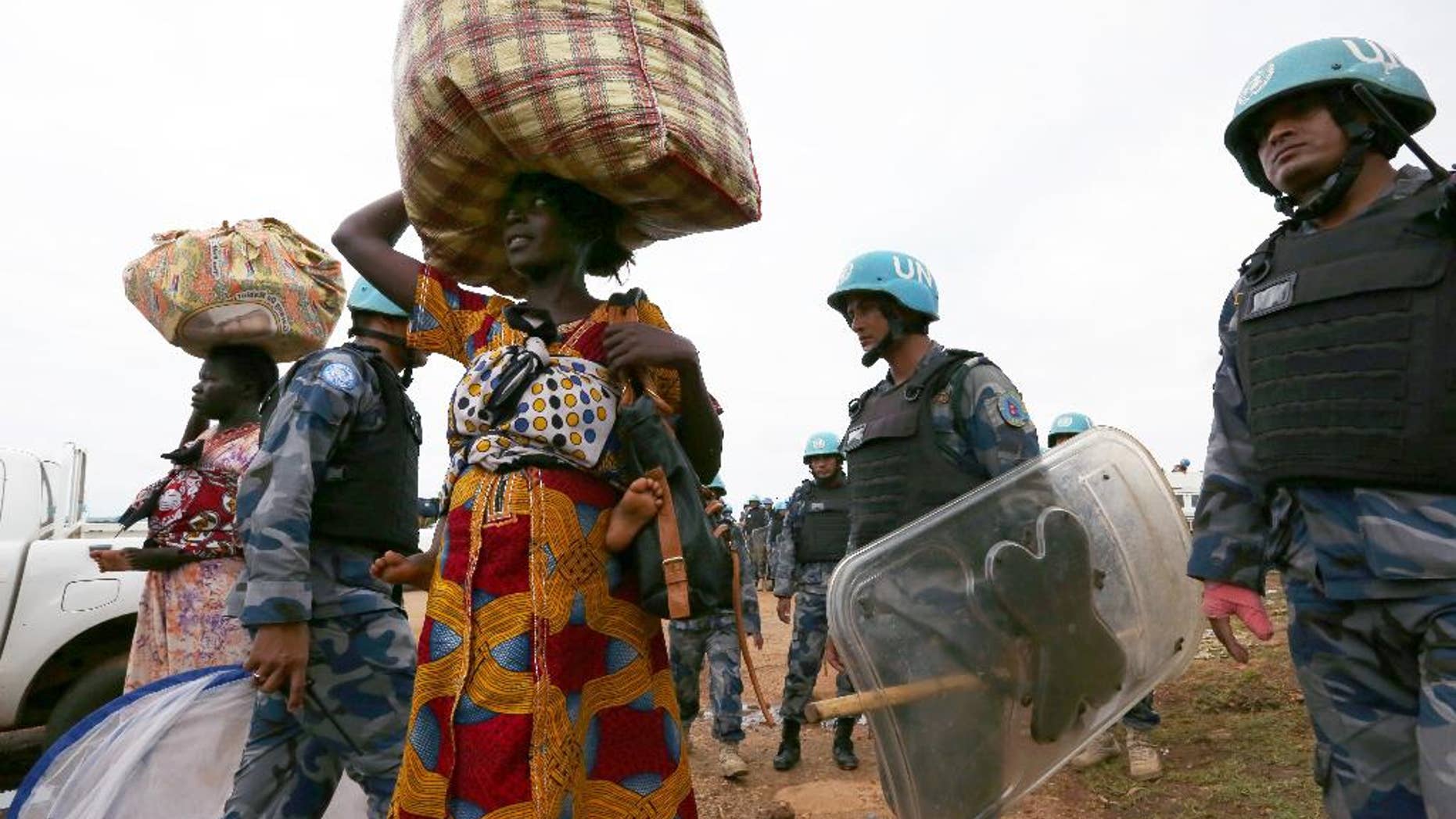 In this photo taken Wednesday, July 13, 2016 and released by the United Nations Mission in South Sudan (UNMISS), villagers and internal displaced people are helped by UN soldiers in the capital Juba, South Sudan. The death toll from a recent outbreak of fighting in South Sudan is almost certain to climb above the 272 people, including 33 civilians, reported by the government, United Nations officials said Wednesday (Eric Kanalstein/UNMISS via AP)