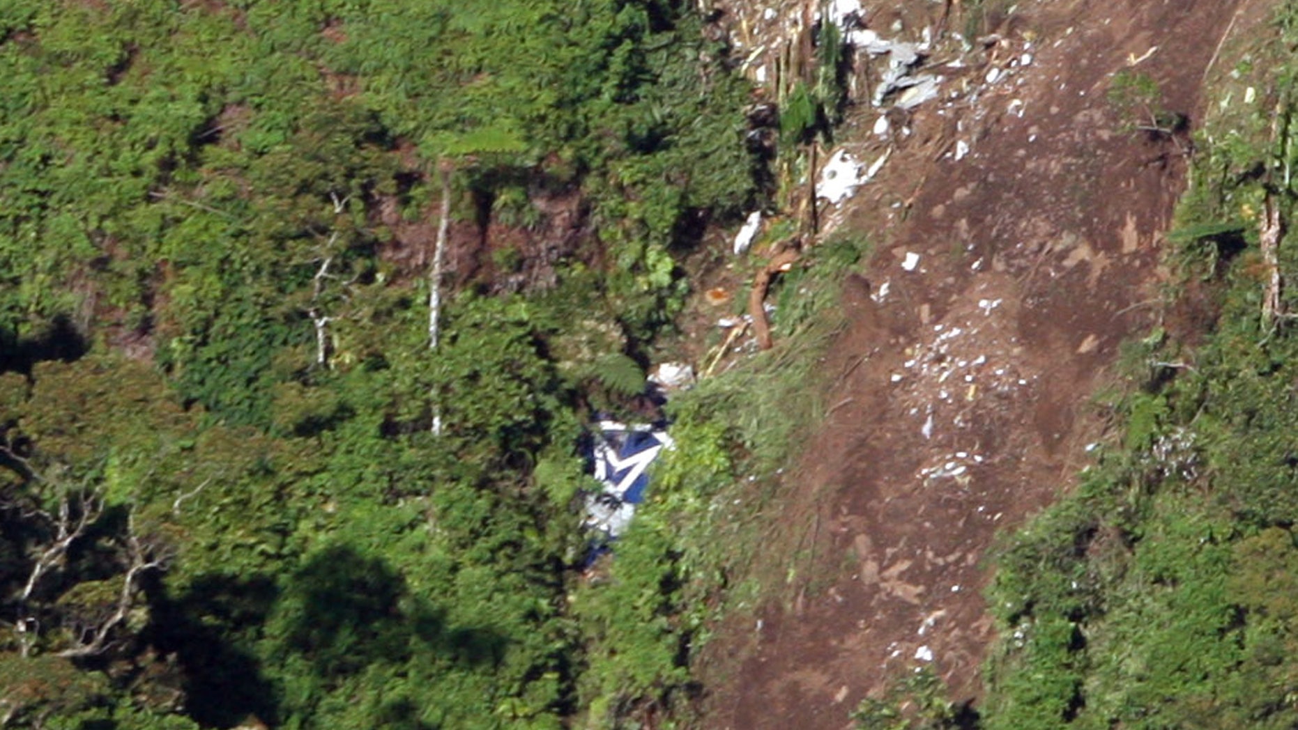 May 11, 2012: The logo of Sukhoi Co. is clearly visible, center, among the wreckage of a Sukhoi Superjet-100 scattered on the mountainside in Bogor, West Java, Indonesia.