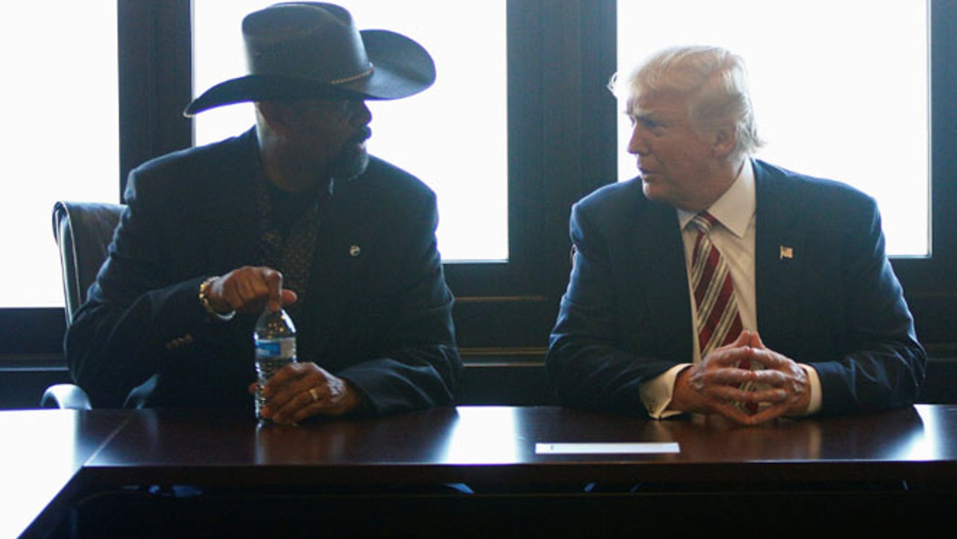 FILE: Then-candidate Donald Trump talks with Milwaukee County Sheriff David Clarke Jr.