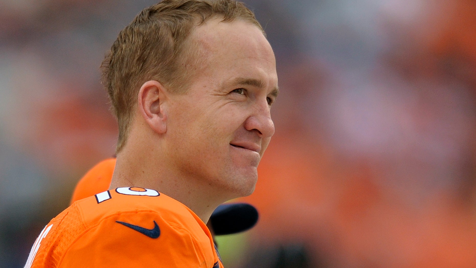 FILE - In this Sept. 29, 2013 file photo, Denver Broncos quarterback Peyton Manning watches play from the sidelines against the Philadelphia Eagles in the fourth quarter an NFL football game, in Denver. Manning returns to Indianapolis on Sunday, Oct. 20, 2013, a better quarterback than the one who left. (AP Photo/Jack Dempsey, File)