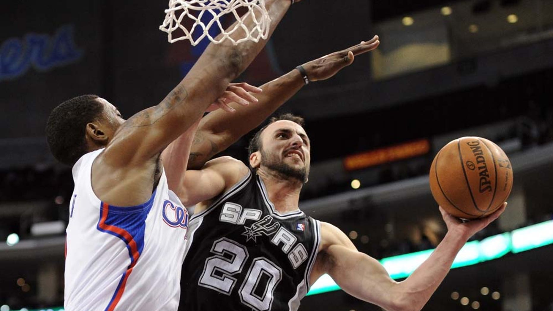 Manu Ginobili #20 of the San Antonio Spurs attempts a shot over the defense of DeAndre Jordan #9 of the Los Angeles Clippers during a 90-85 Clipper win at the Staples Center on December 1, 2010 in Los Angeles, California.