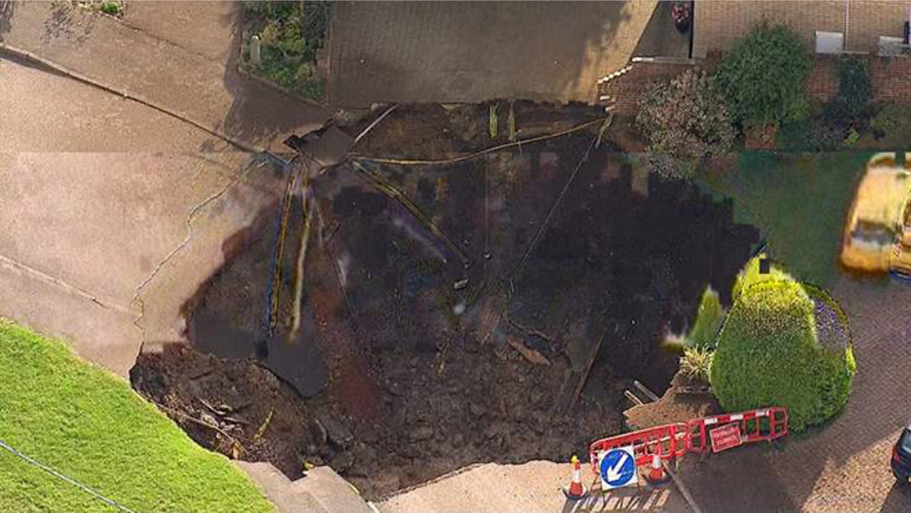 A sinkhole in St Albans, UK, has cut off more than 50 homes.