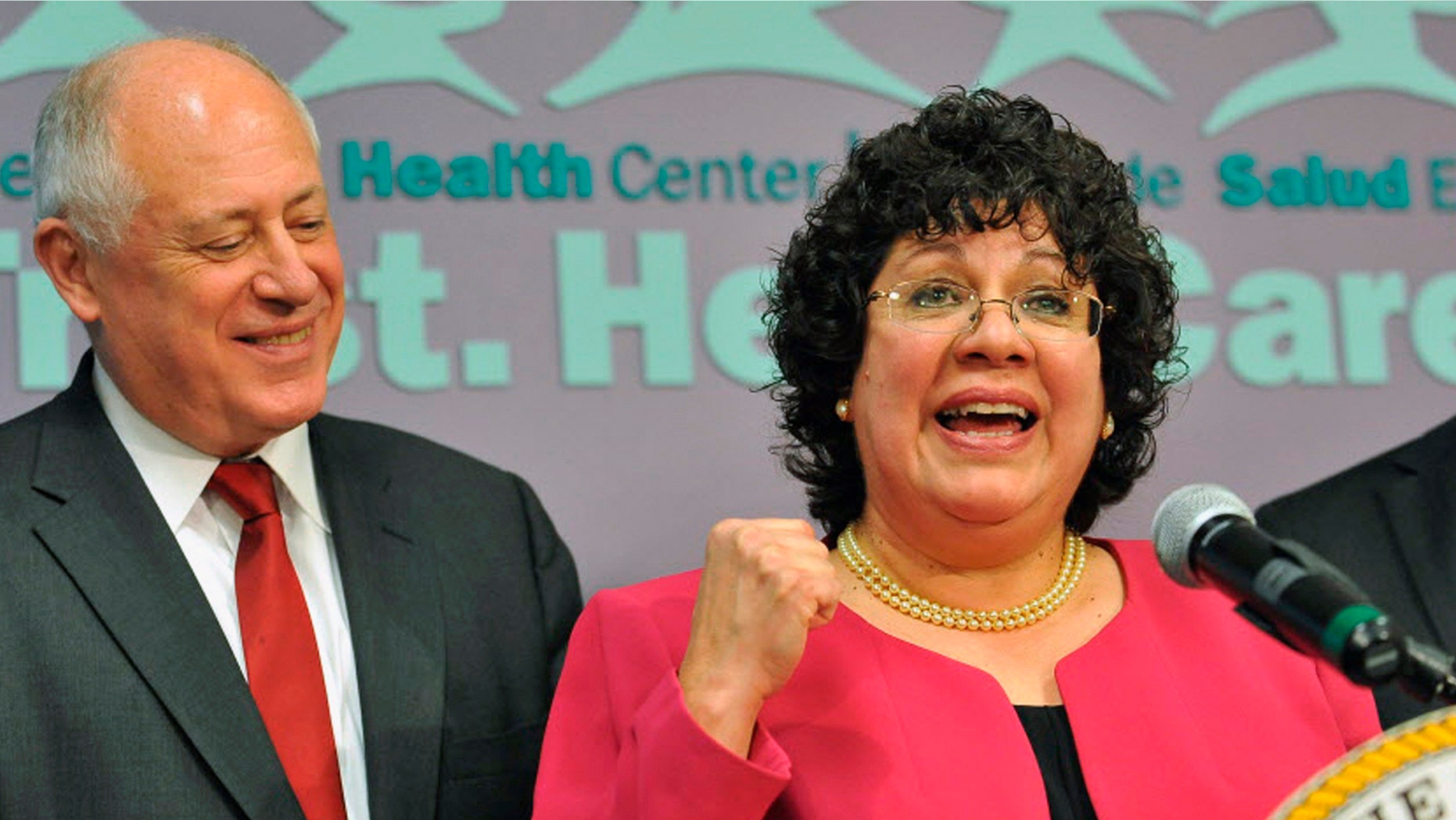 Celeste Castillo at a news conference in Chicago as Gov. Pat Quinn looks on.