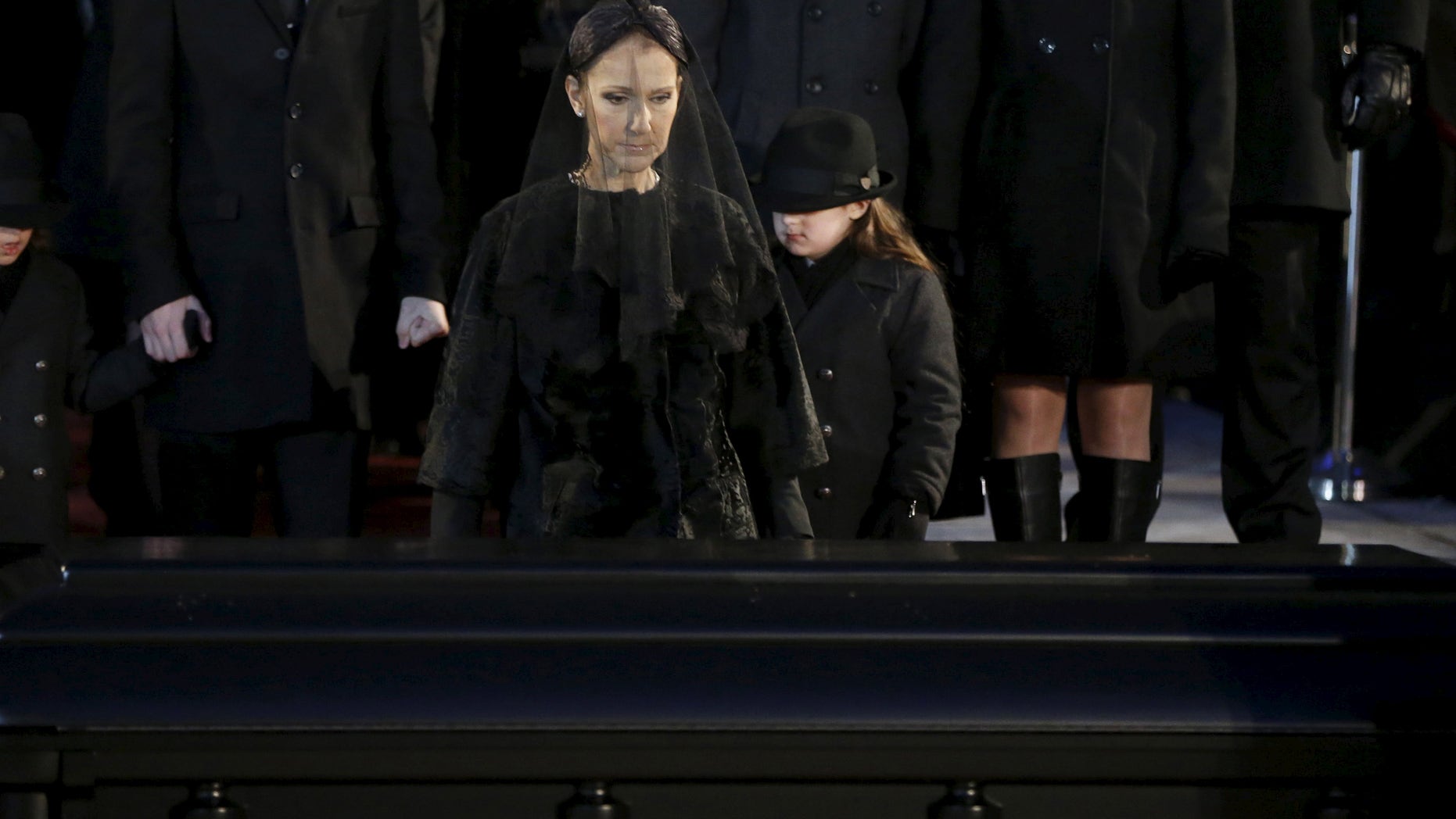 January 22, 2016. Singer Celine Dion walks up to the casket of her husband Rene Angelil following his funeral at Notre Dame Basilica in Montreal.