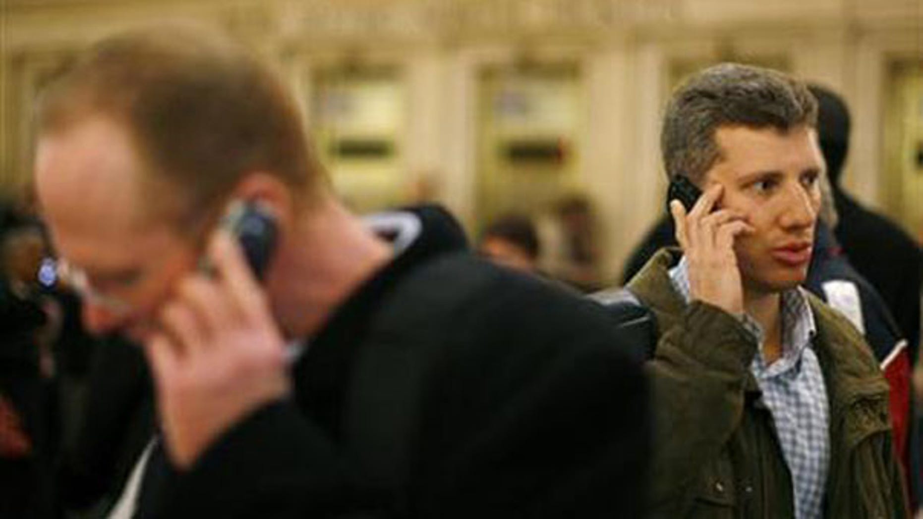 Two men talk on cell phones inside Grand Central Station in New York in this March 4, 2008, file photo. (Reuters Photo)