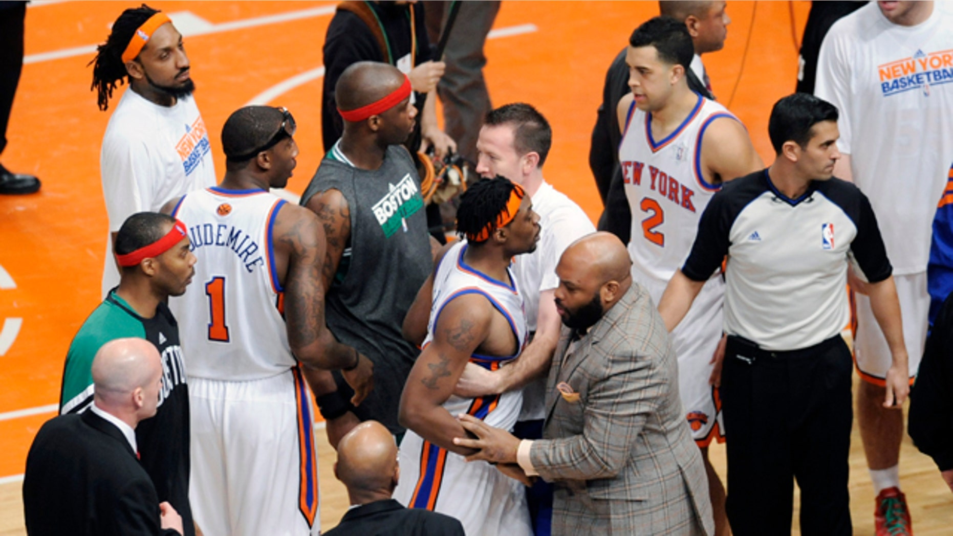 Dec. 25, 2011: New York Knicks' Bill Walker is restrained at the end of the NBA basketball game against the Boston Celtics at Madison Square Garden in New York.