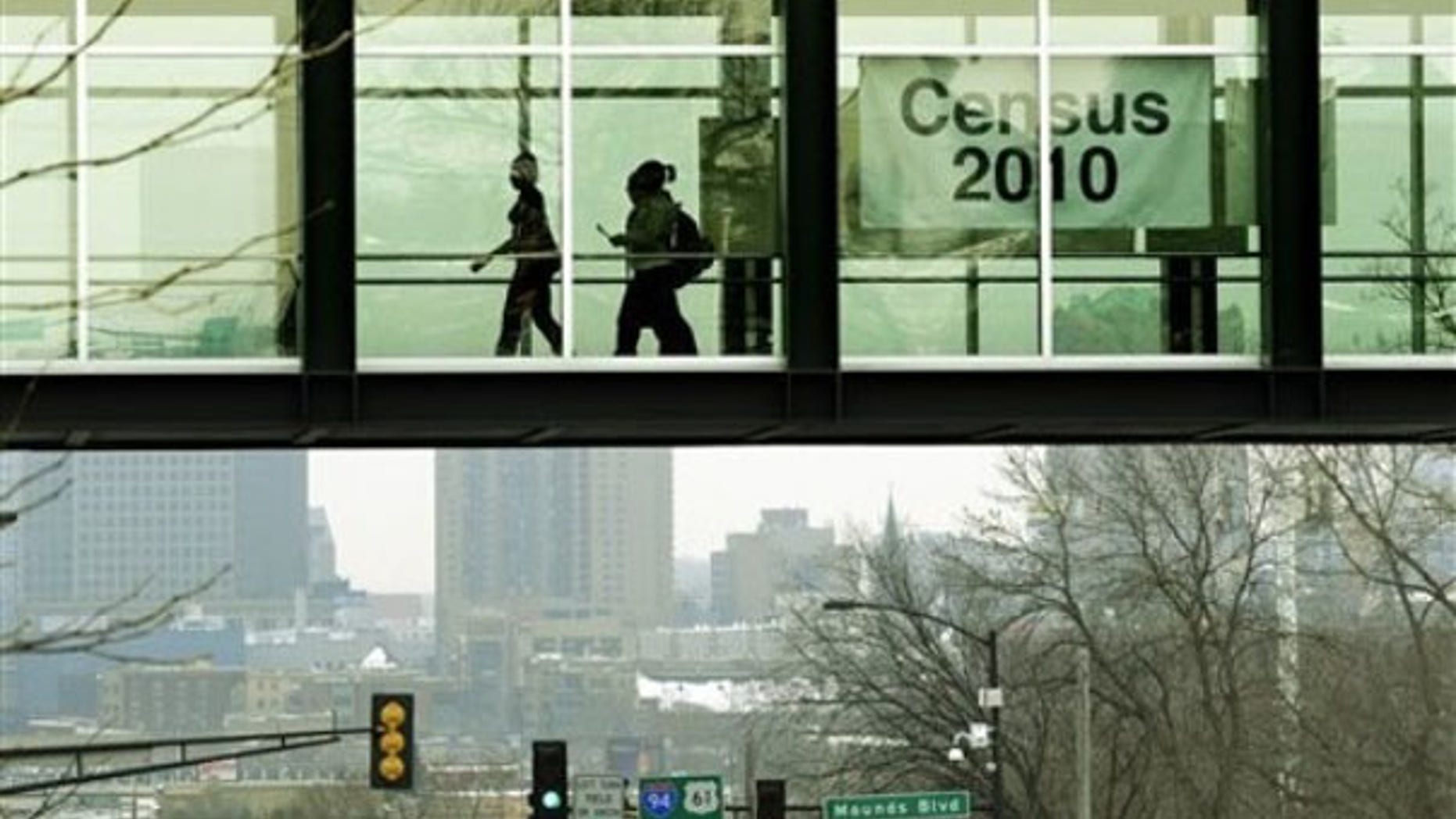 In this Jan. 15, 2010, photo, students at Metropolitan State University in St. Paul, Minn., walk past a census poster. (AP Photo)