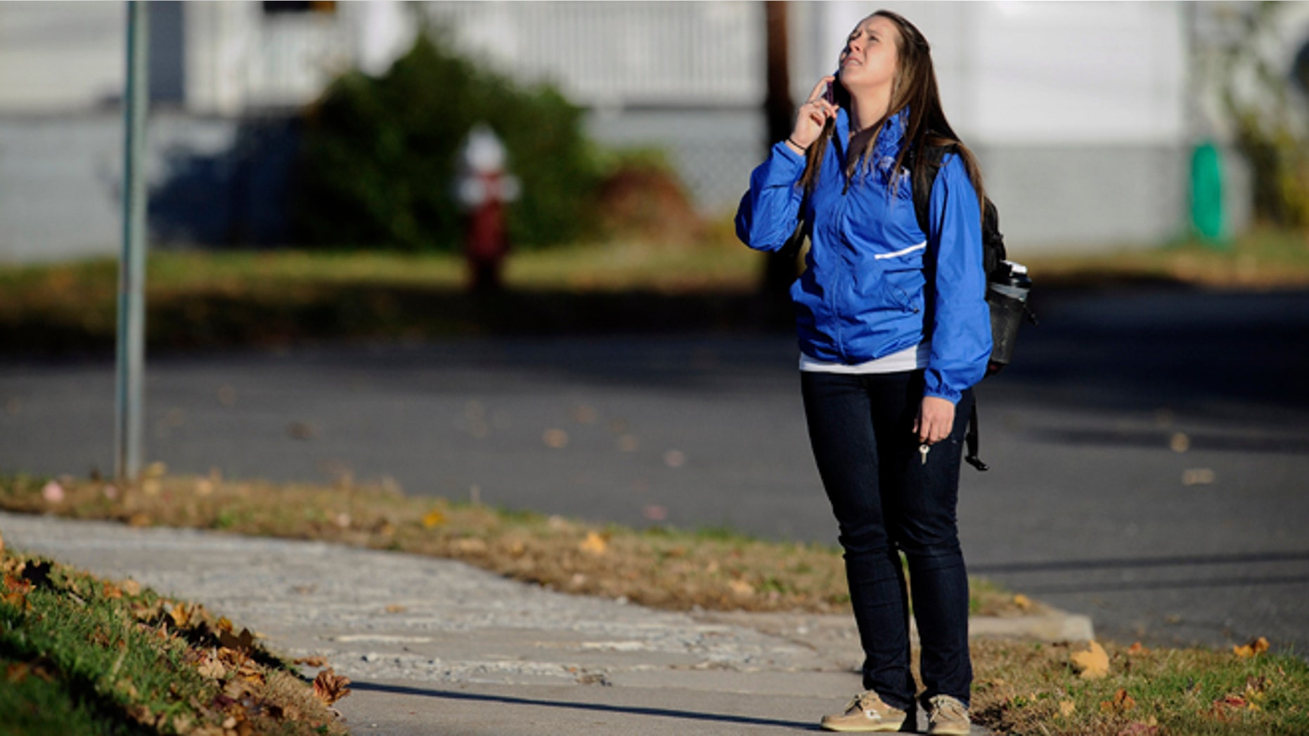 Nov. 4, 2013: A student waits to return to campus following a lockdown due to a sighting of an armed man at Central Connecticut State University in New Britain, Conn.