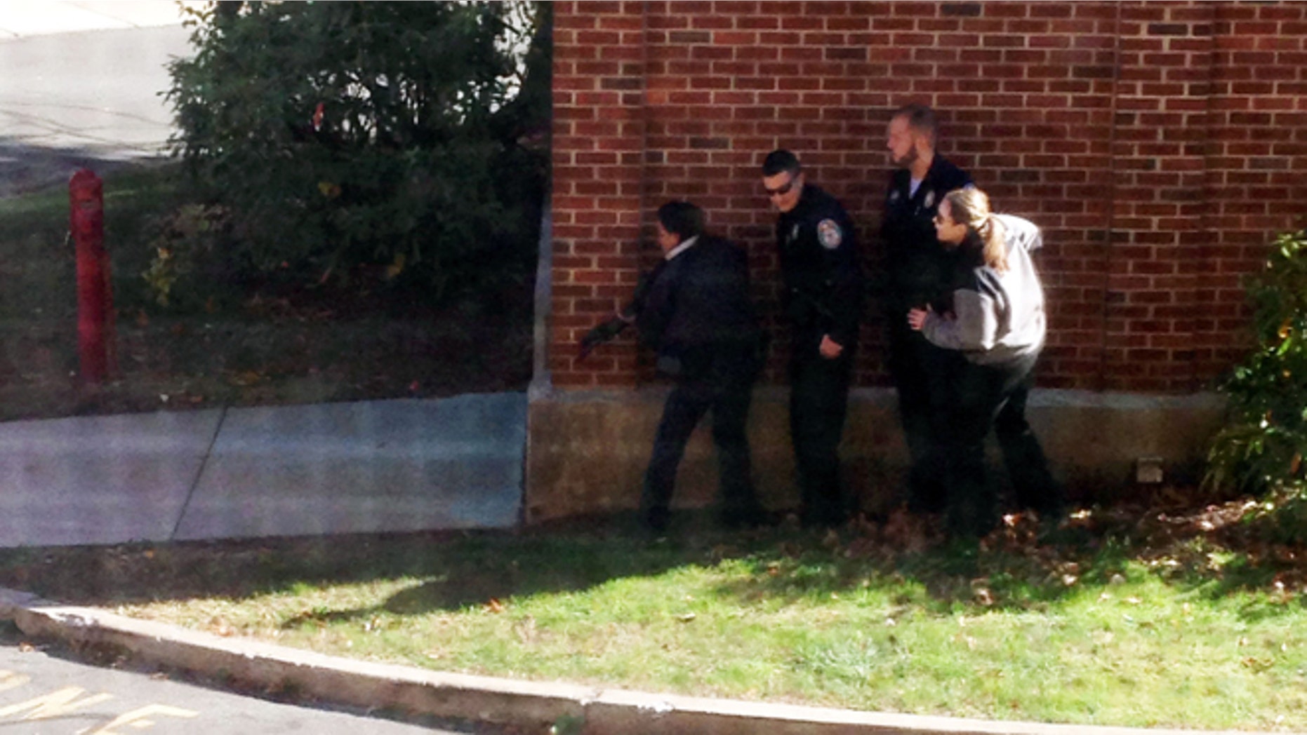 Nov. 4, 2013: In this photo taken through a window and provided to the AP, which has been authenticated based on its contents and other AP reporting, police officers respond to a report of a suspicious person at Central Connecticut State University in New Britain, Conn.