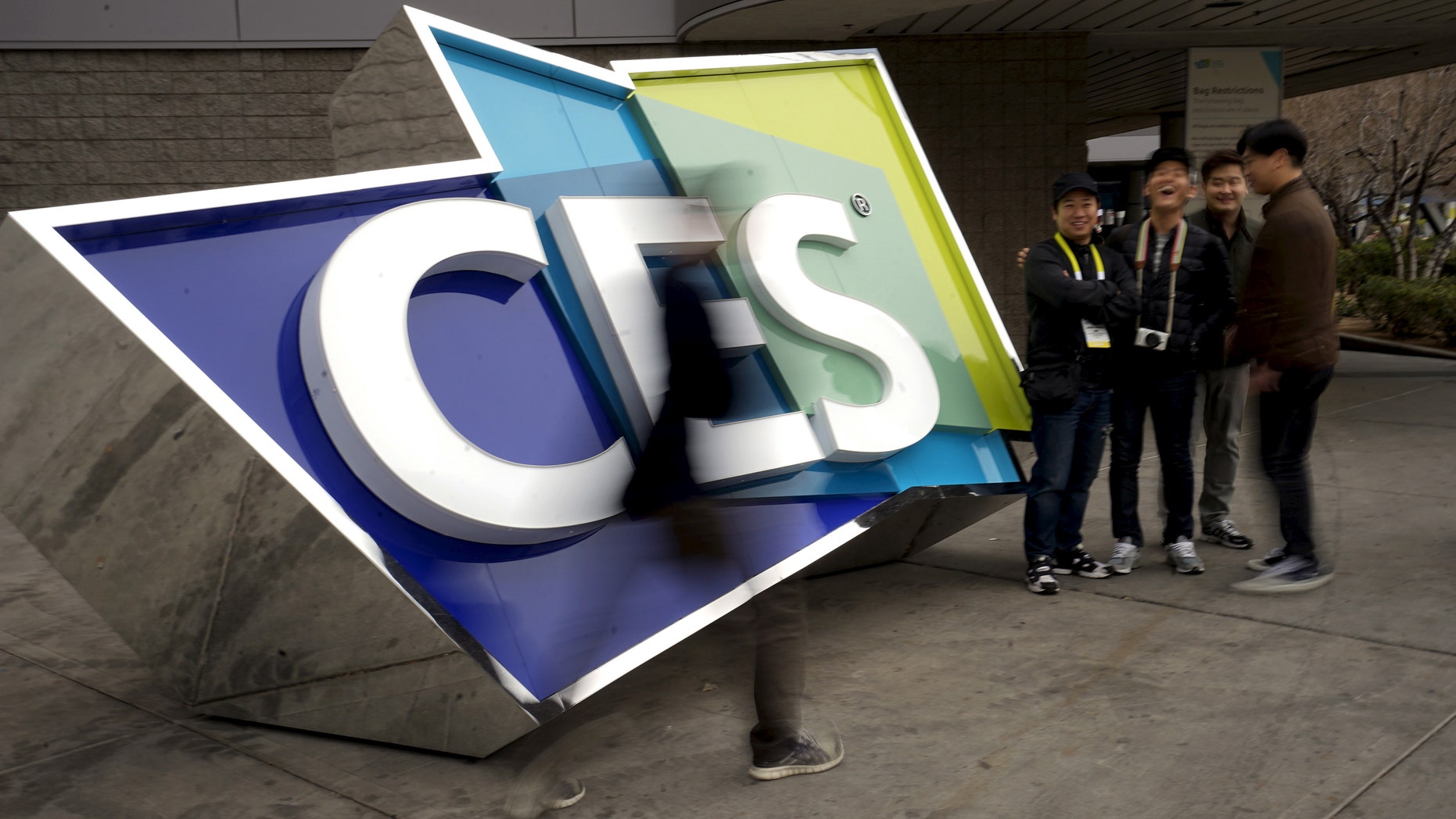 File photo - attendees pass by a sign outside the Consumer Electronics Show in Las Vegas, Jan. 5, 2016. (REUTERS/Rick Wilking)