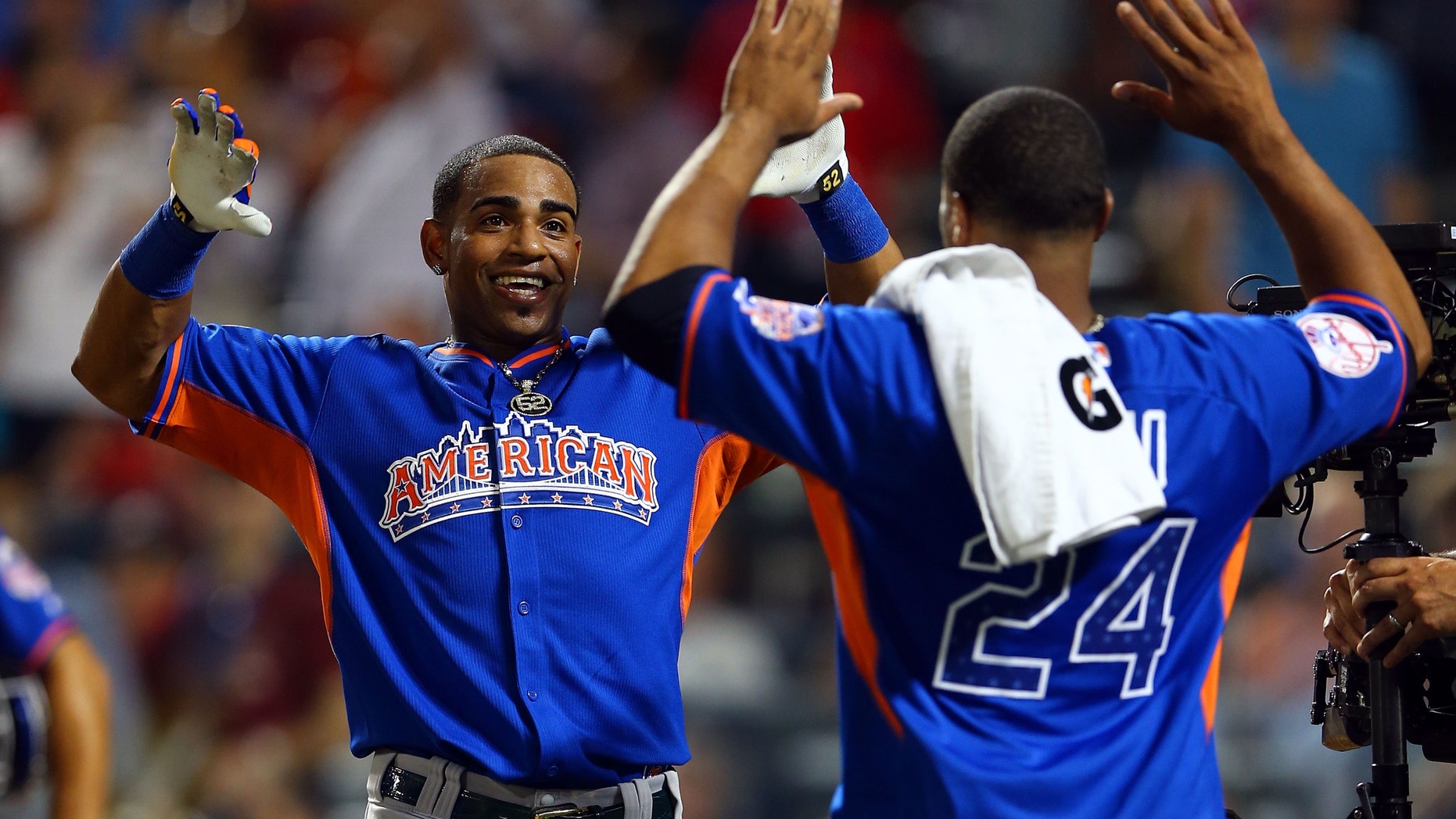 NEW YORK, NY - JULY 15: Yoenis Cespedes of the Oakland Athletics celebrates with Robinson Cano of the New York Yankees after winning the Chevrolet Home Run Derby on July 15, 2013 at Citi Field in the Flushing neighborhood of the Queens borough of New York City. (Photo by Elsa/Getty Images)