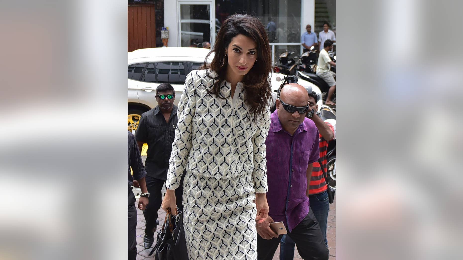Human rights lawyer Amal Clooney arrives to meet with Attorney General Mohamed Anil at Velaanaage Attorney Generals Office in Male, Maldives, Wednesday, Sept. 9, 2015. Clooney attended a hearing Wednesday to appeal a 13-year jail sentence given to Maldives' former president Mohamed Nasheed and met with the attorney general to discuss the case. She is part of a three-member international legal team trying to secure Nasheed's release.(AP Photo/ Mohamed Sharuhaan)