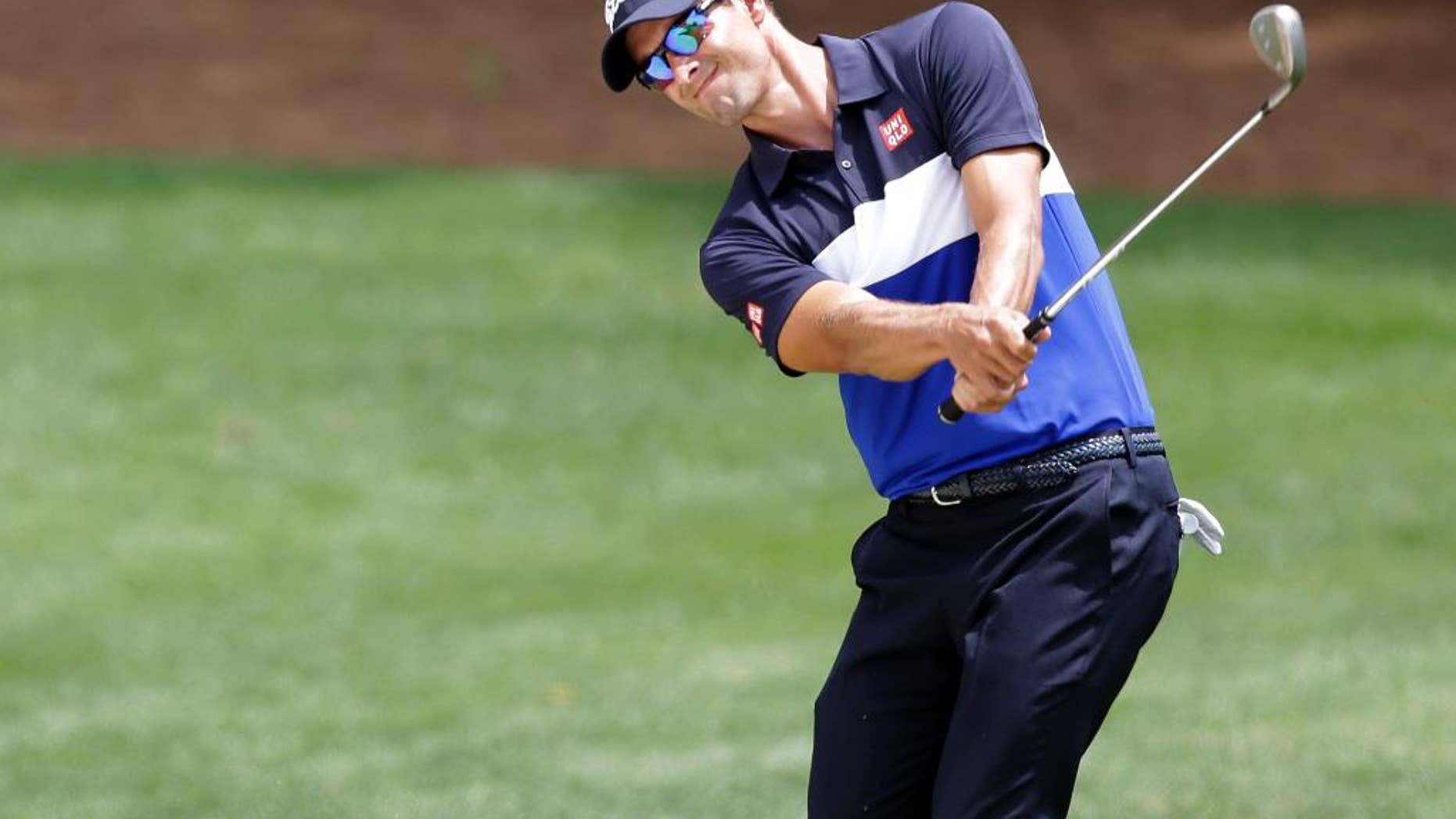 Adam Scott, of Australia, chips to the fourth green during the first round of the Wells Fargo Championship golf tournament at Quail Hollow Club in Charlotte, N.C., Thursday, May 14, 2015. (AP Photo/Bob Leverone)