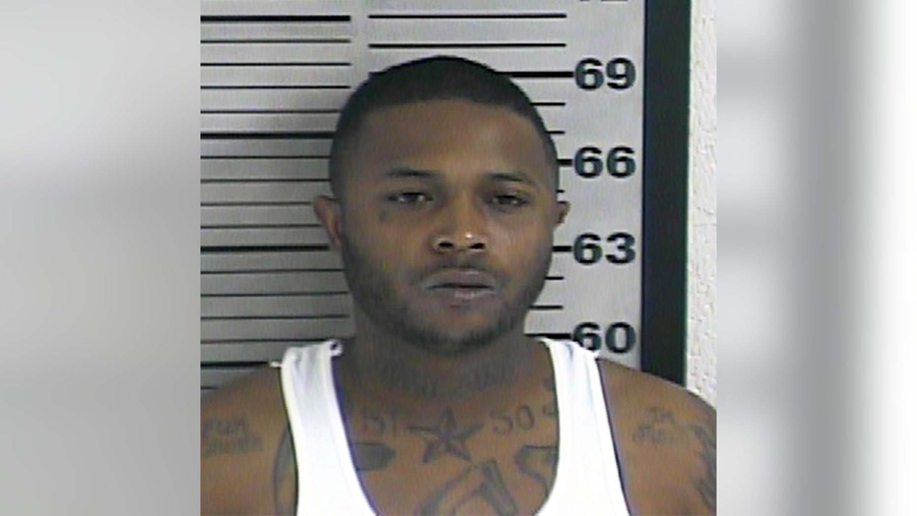 In this photo made available by the Dyer County Sheriff's Office, Tenn., on Friday, Nov. 18, 2016, shows Torius Russell under arrest. Authorities accuse Russell of fatally shooting the mother of a 2-year-old during the child's birthday party in Dyersburg, Tenn., Thursday, Nov. 17, 2016. (Dyer County Sheriff's Office via AP)