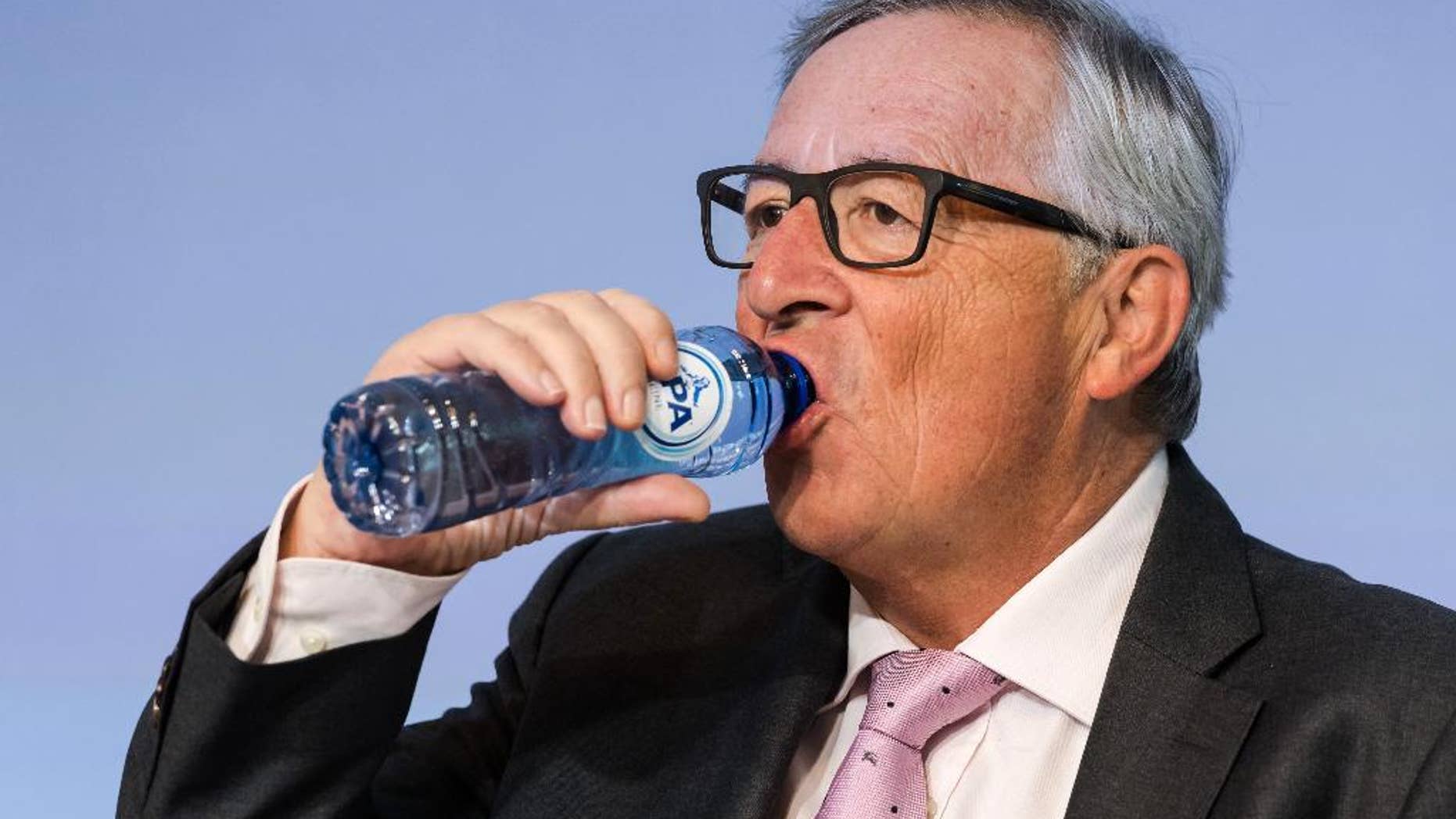 European Commission President Jean-Claude Juncker drinks water as he attends a plenary session of European Economic and Social Committee at the EU Charlemagne building in Brussels Thursday, Sept. 22, 2016. (AP Photo/Geert Vanden Wijngaert)