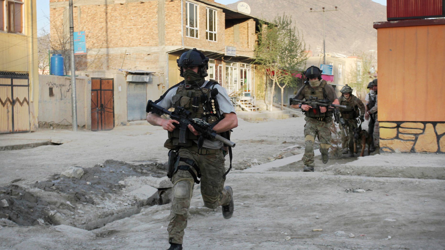 April 15: NATO soldiers run during a gun battle in Kabul, Afghanistan.