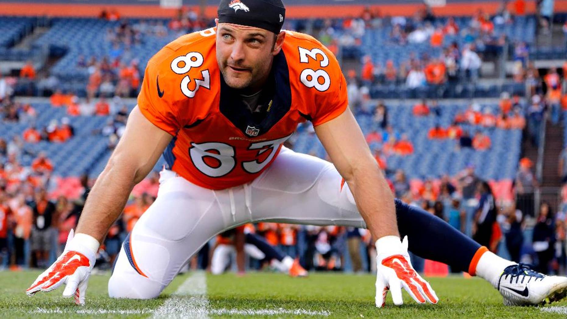 FILE - In this Aug. 23, 2014, file photo, Denver Broncos wide receiver Wes Welker (83) stretches prior to an NFL preseason football game against the Houston Texans in Denver. The Broncos will be without Welker for the first four games of the season after the NFL said the receiver violated the league's performance-enhancing drug policy. Normally, the league announces such violations on Monday. News of Welker's ban didn't come down until late Tuesday, Sept. 2, 2014, after the league offices had closed and the Broncos had already finished drawing up blueprints for their opener against Indianapolis, undoubtedly with Welker playing a prominent role.(AP Photo/Jack Dempsey, File)