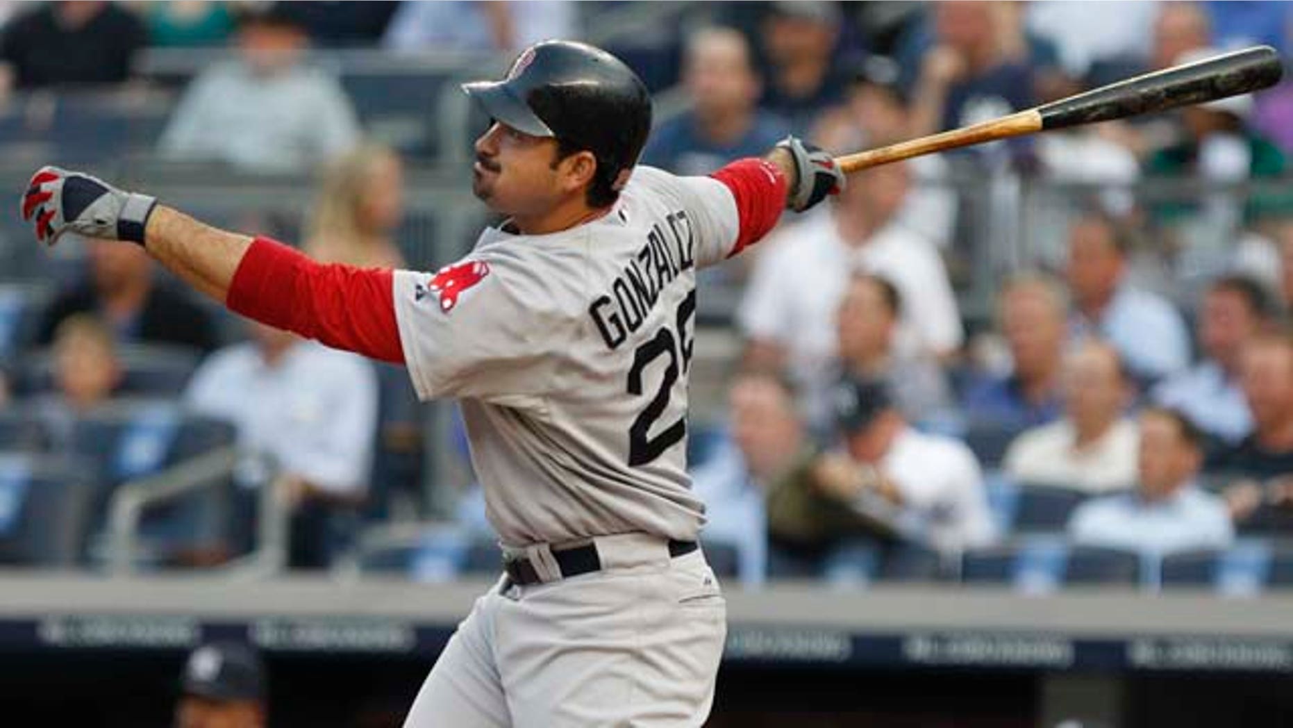 Boston Red Sox's Adrian Gonzalez follows through on an RBI triple during the first inning of a baseball game ,Tuesday, June 7, 2011, at Yankee Stadium in New York. (AP Photo/Frank Franklin II)