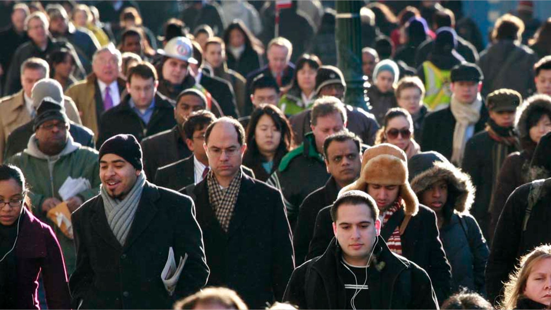 FILE - In this Jan. 21, 2010 file photograph, New Yorkers walk to work. The income gap between the richest and poorest Americans grew last year to its widest amount on record as young adults and children in particular struggled to stay afloat in the recession. (AP Photo/Mark Lennihan, file)