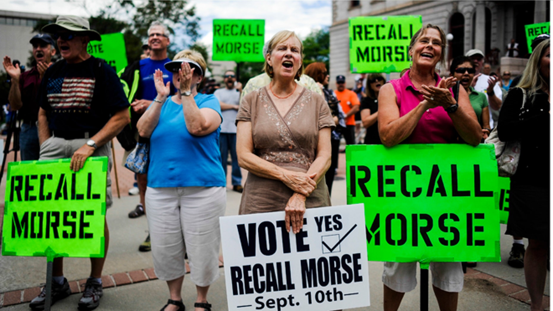 FILE: Sept. 4, 2013: Supporters of the recall election to oust state Senate President John Morse rally outside the Pioneer Museum in Colorado Springs, Colo.