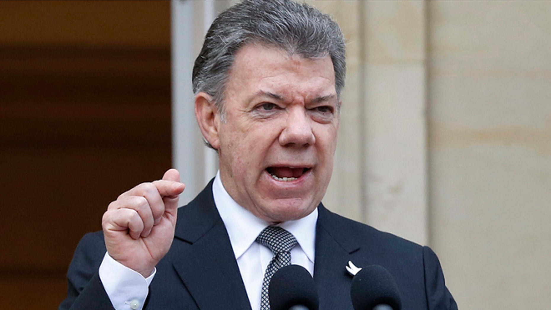 Colombia's President Juan Manuel Santos speaks to the media after a welcoming ceremony for South Korea's President Park Geun-hye at the presidential palace in Bogotá, Colombia, Friday, April 17, 2015. In a sharply worded rebuke, Santos said Colombians' patience is wearing thin after guerrillas this week attacked an army platoon sleeping in the field and killed 11 soldiers. (AP Photo/Fernando Vergara)