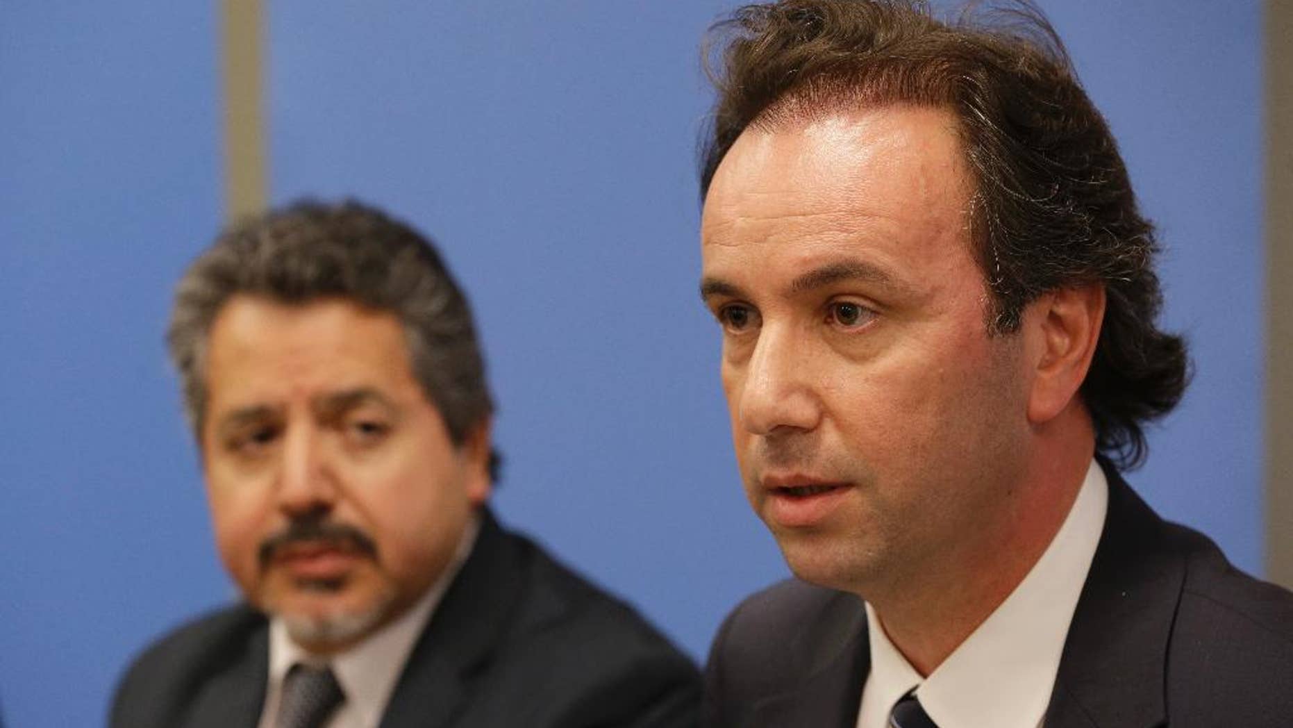President of the Syrian National Coalition Khaled Khoja, right, is joined by Syrian National Coalition Special Representative to the U.S. and the United Nations Najib Ghadbian as he speaks to reporters during a news conference, Wednesday, Sept. 30, 2015 at U.N. headquarters. (AP Photo/Mary Altaffer)