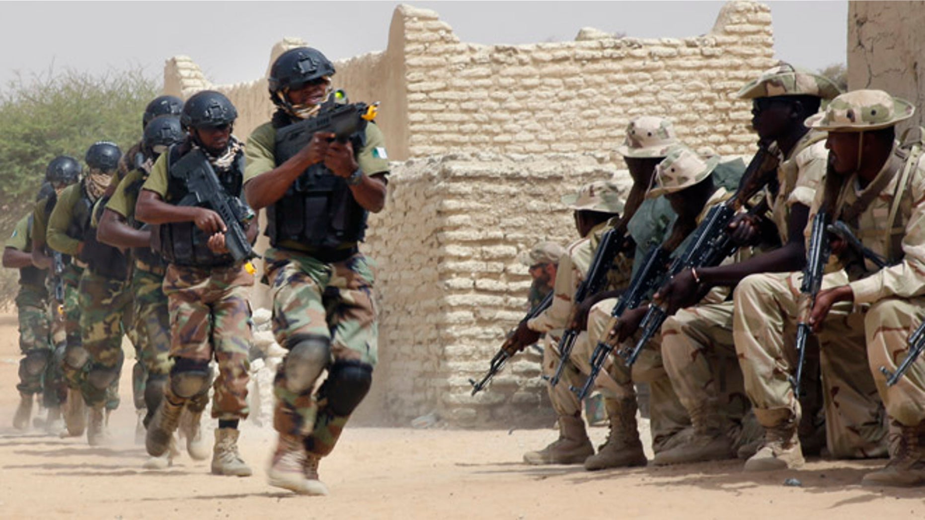 March 7, 2015: Nigerian special forces run past Chadian troops in an hostage rescue exercise at the end of the Flintlock exercise in Mao, Chad. The U.S. military and its Western partners conduct this training annually and set up plans long before Boko Haram began attacking its neighbors Niger, Chad and Cameroon.