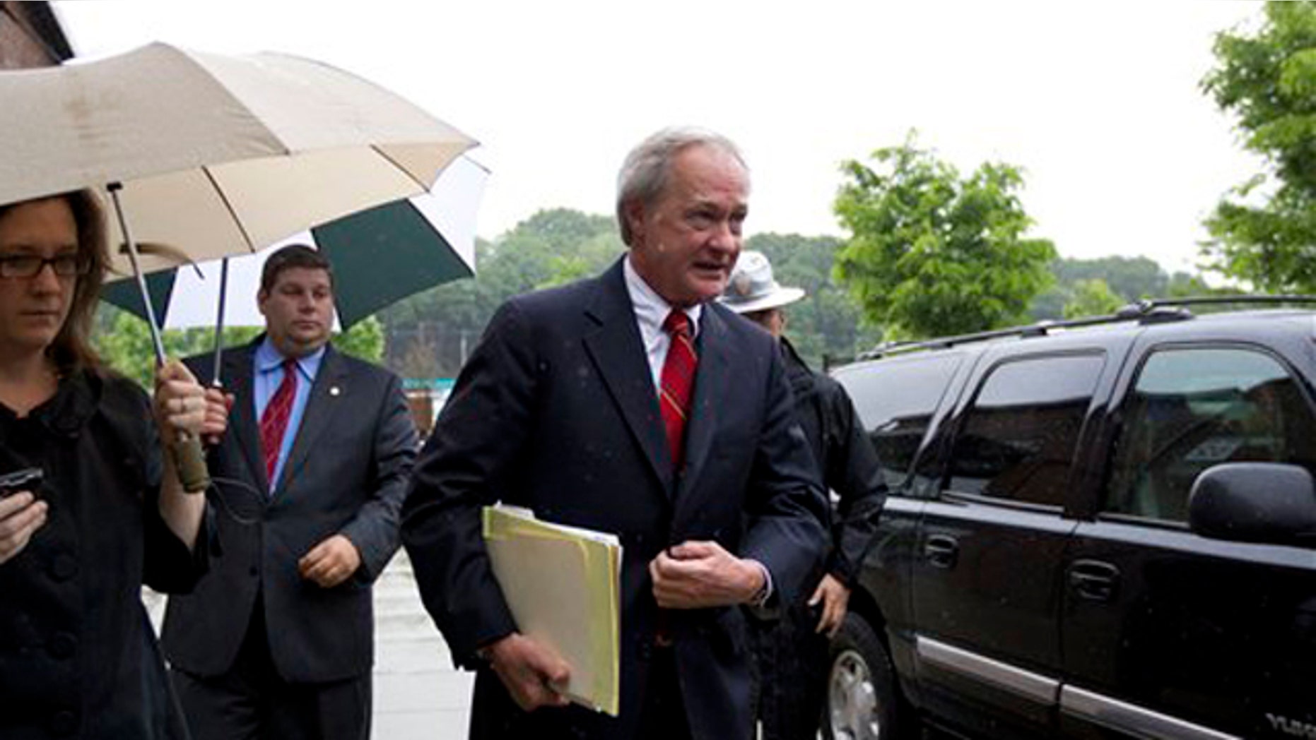 May 21, 2012: Rhode Island Gov. Lincoln Chafee, center, arrives at the state's Economic Development Corp. headquarters in Providence, R.I.