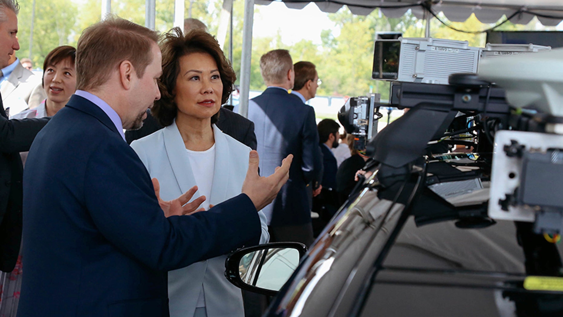 U.S. Transportation Secretary Elaine Chao looks at autonomous vehicle technology after announcing new voluntary safety guidelines for self-driving cars during a visit to an autonomous vehicle testing facility, Tuesday, Sept. 12, 2017, at the University of Michigan, in Ann Arbor, Mich. The new guidelines update policies issued last fall by the Obama administration, which were also largely voluntary. (Hunter Dyke/The Ann Arbor News via AP)