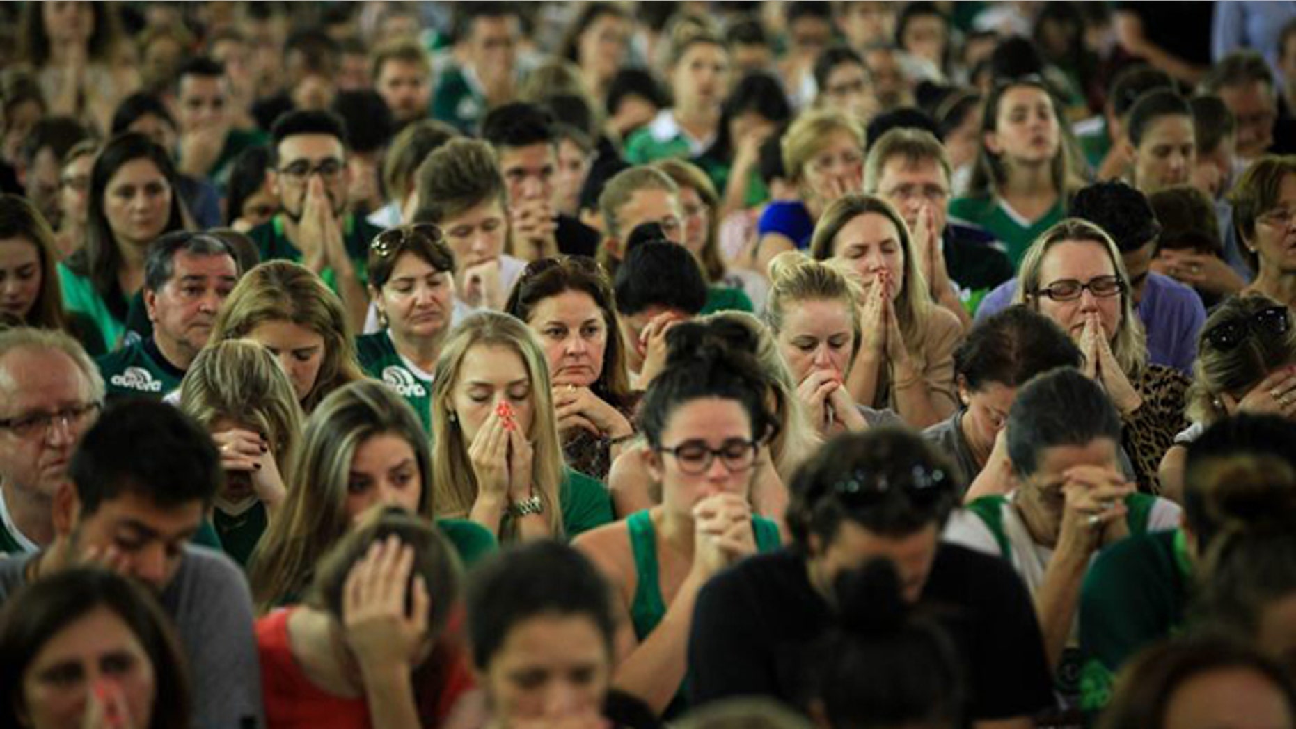 Chapecoense fans attend a mass in Chapeco, Brazil, 29 November 2016. According to reports, 71 people died when an aircraft crashed late 28 November 2016 with 77 people on board, including players of the Brazilian soccer club Chapecoense. Four people registered on the passengers list did not board the plane. The plane crashed in a mountainous area outside Medellin, Colombia as it was approaching the Jose Maria Cordoba airport. The cause of the incident is as yet uknown. Chapecoense were scheduled to play in the Copa Sudamericana final against Medellin's Atletico Nacional on 30 November 2016. (Photo: EPA/Fernando Bizerra Jr.)