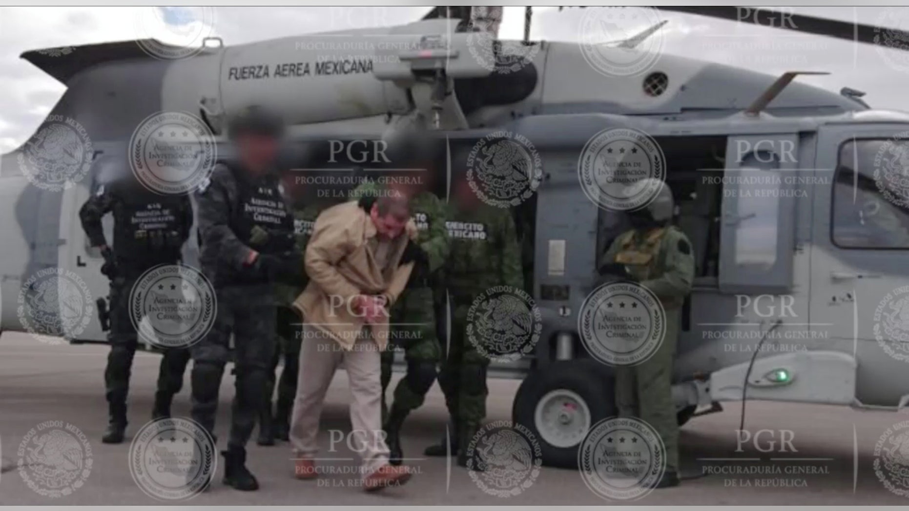 Joaquin "El Chapo" Guzman is escorted by soldiers in Ciudad Juarez, Mexico, as he is extradited to New York in this handout image made available January 19, 2017.