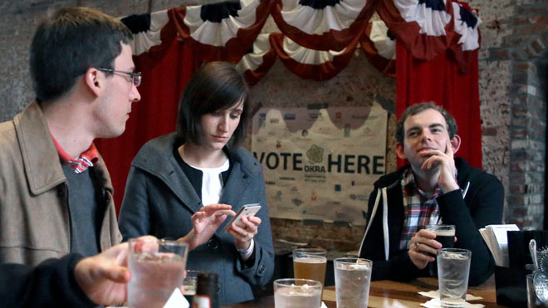 Dec. 13, 2013: In this photo, Jesse Mello, left, Erin Holt, center, and Matt Pankey enjoy drinks at The Original OKRA Charity Saloon in Houston. The gives 100 percent of its profits to charity and is set to donate more than $300,000 after its first year.