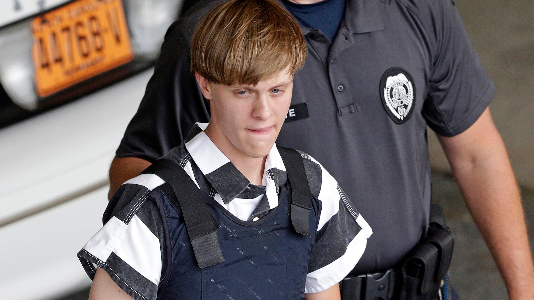 In this June 18, 2015 file photo, Charleston, S.C., shooting suspect Dylann Storm Roof is escorted from the Cleveland County Courthouse in Shelby, N.C