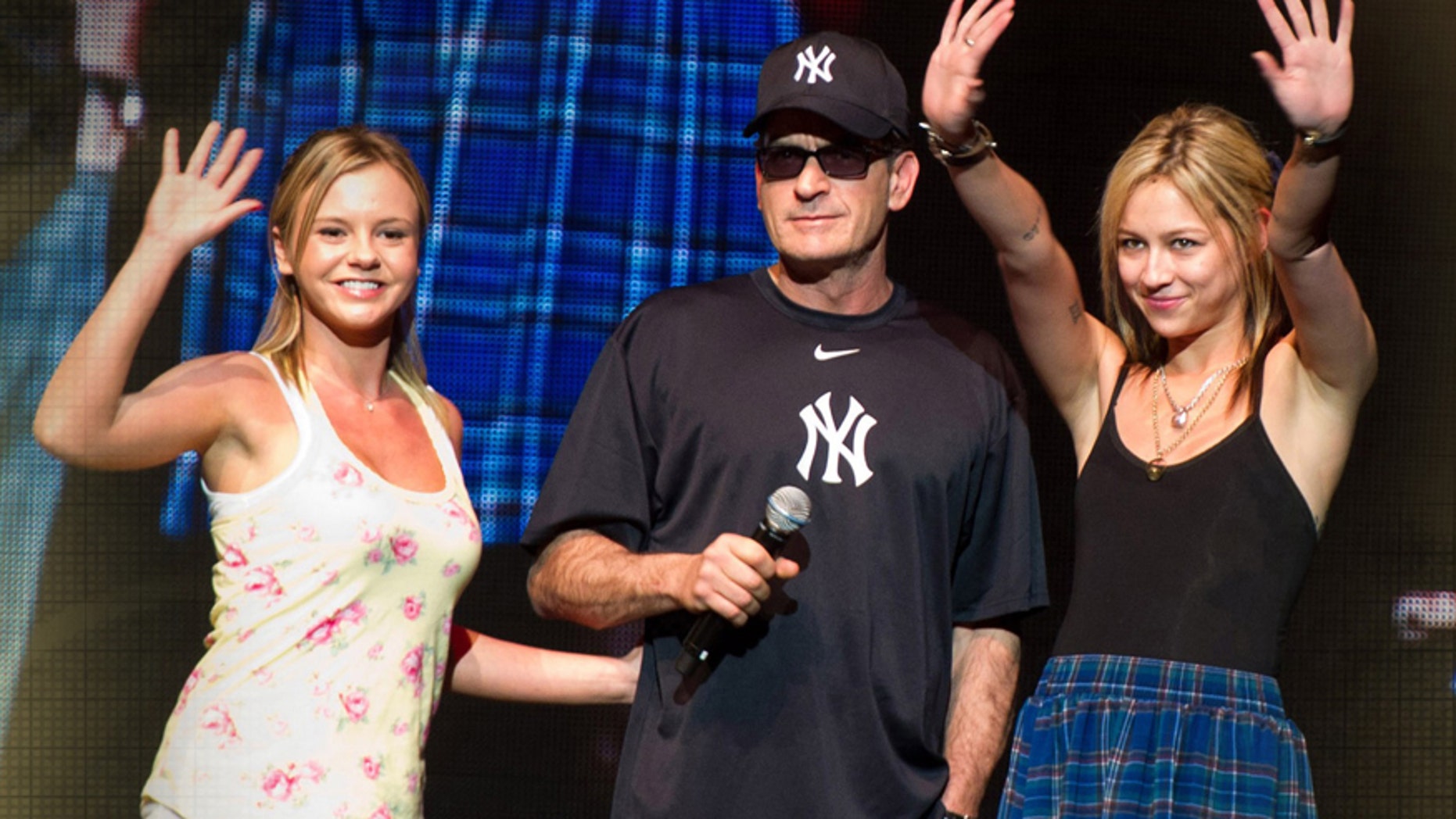 Charlie Sheen (center) on stage with his "Goddesses" Rachel Oberlin , aka Bree Olson (l) and Natalie Kenly (r), onstage during "My Violent Torpedo of Truth/Defeat is Not An Option Show", Radio City Music Hall, New York, 2011.