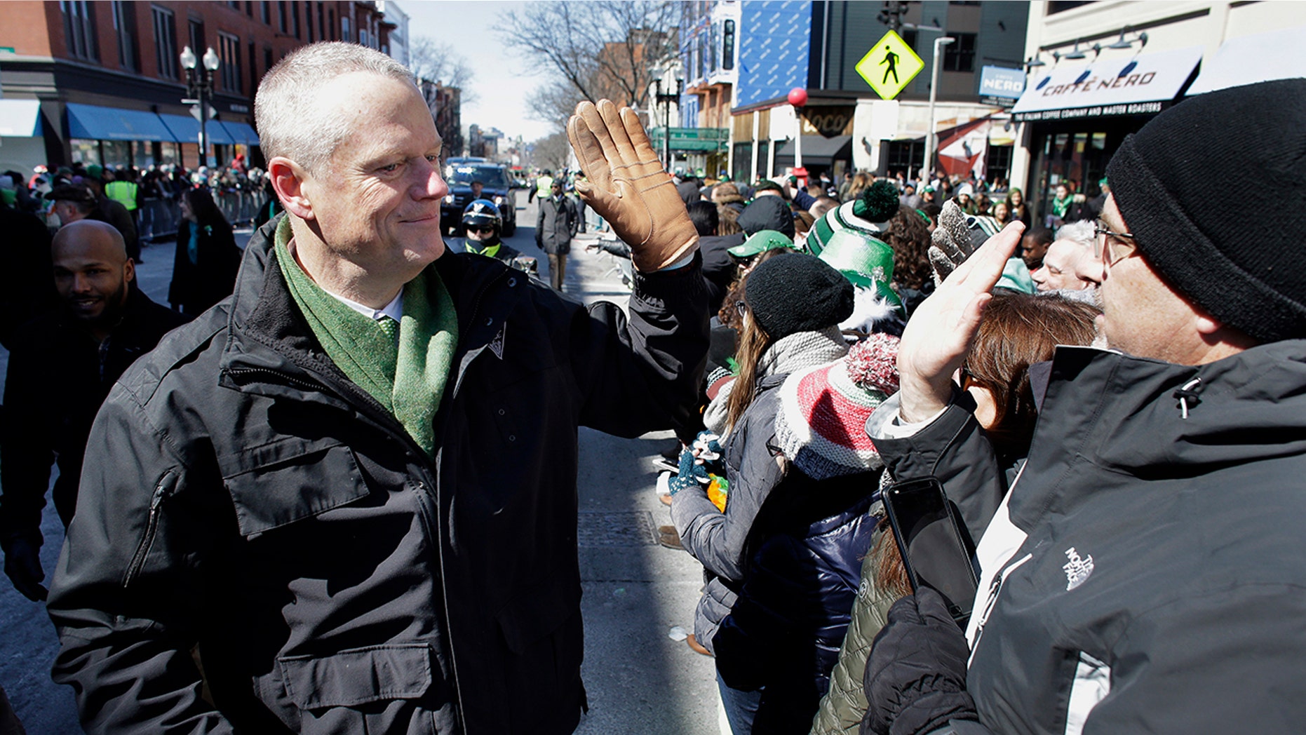 Massachusetts Gov. Charlie Baker shakes hands with constituents at the annual St. Patrick's Day parade in Boston on Sunday.