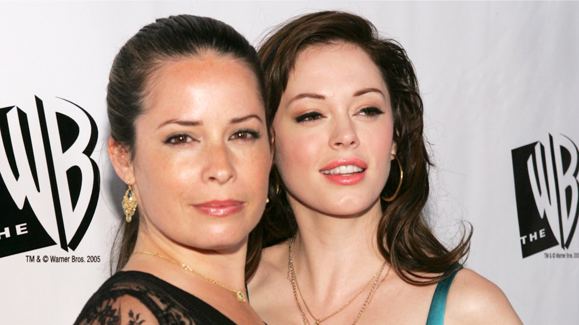"Charmed" cast member Holly Marie Combs criticizes new reboot. Here, Combs (left) with co-star Rose McGowan, arrive for The WB's All-Star Party at the Cabana Club in Hollywood July 22, 2005.