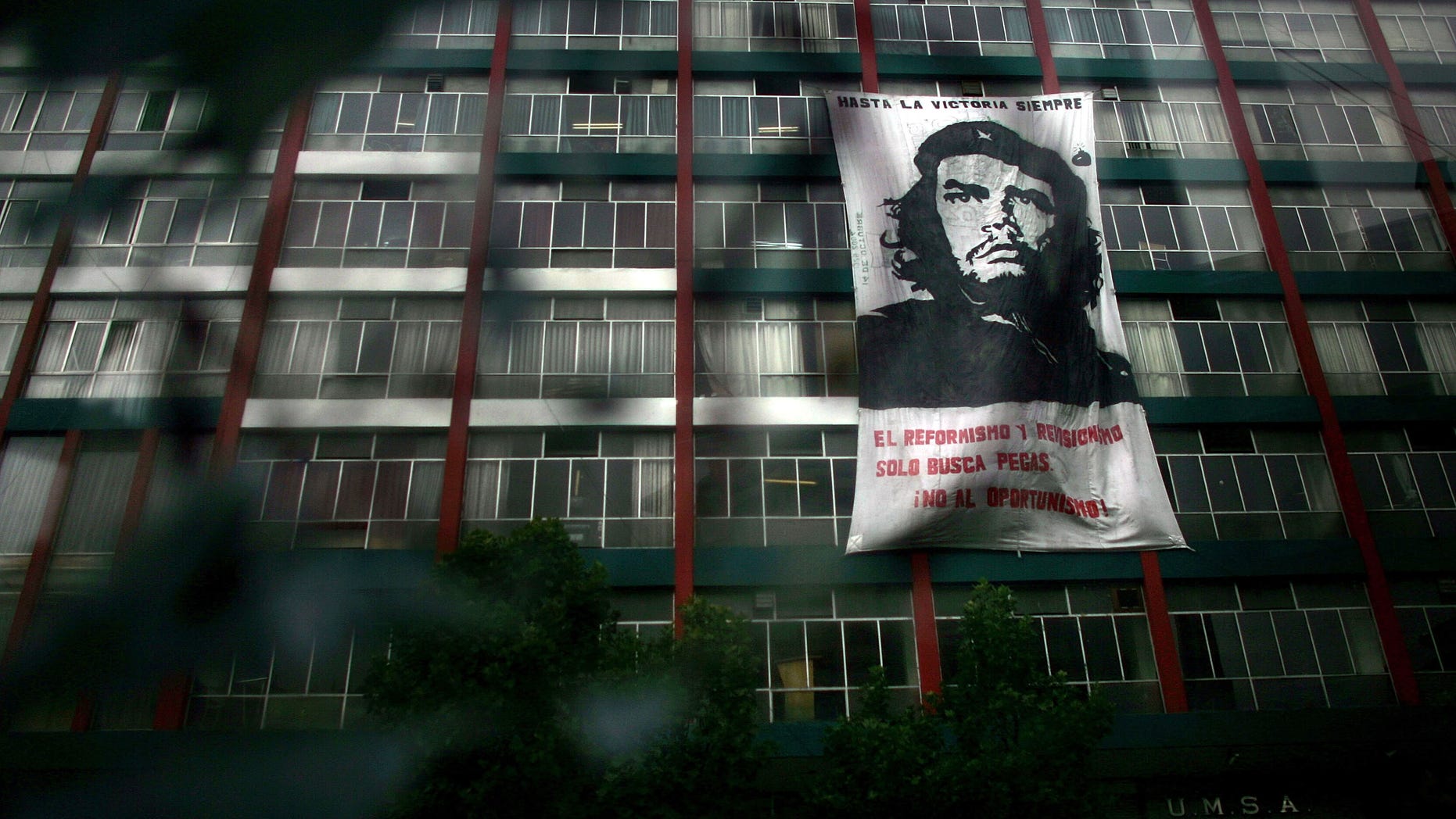 Dec 19: A picture of Che Guevara, the revolutionarily figure who was killed by the Bolivian Military in 1967, hangs from a building.