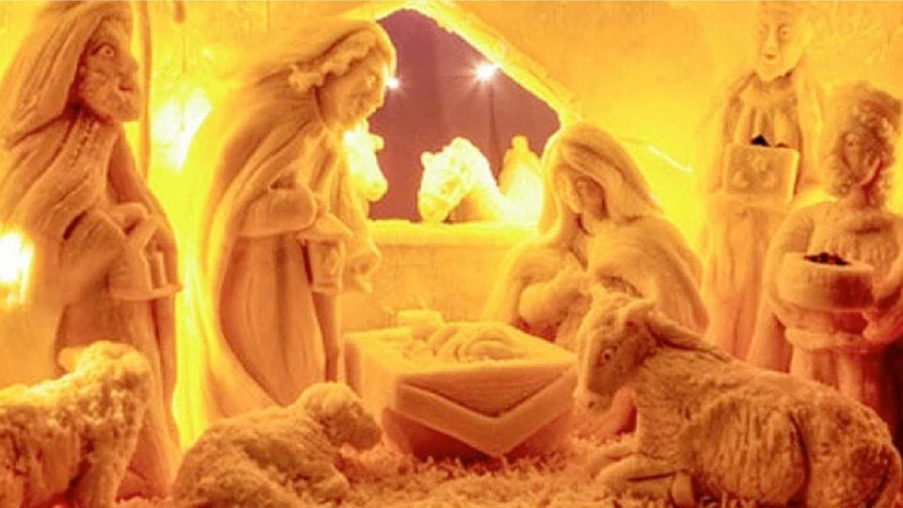 The scene contains two donkeys, two sheep, a cow and Three Wise Men carrying gifts for the baby Jesus.