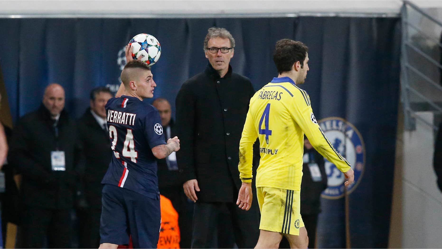 Feb. 17, 2015: PSG's Marco Verratti prepares a throw-in while PSG's head coach Laurent Blanc, center, looks on and Chelsea's Cesc Fabregas, right, passes by during the Champions League round of 16 first leg soccer match between Paris Saint Germain and Chelsea.