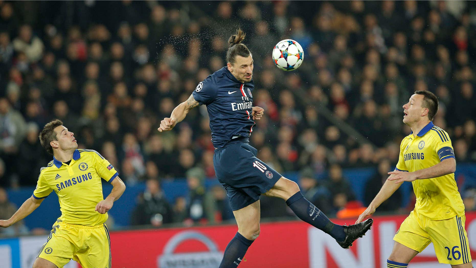 Feb. 17, 2015: PSG's Zlatan Ibrahimovic, centre, heads the ball watched by Chelsea's Cesar Azpilicueta, left, and John Terry during the Champions League round of 16 first leg soccer match between Paris Saint Germain and Chelsea at the Parc des Princes stadium in Paris, France.