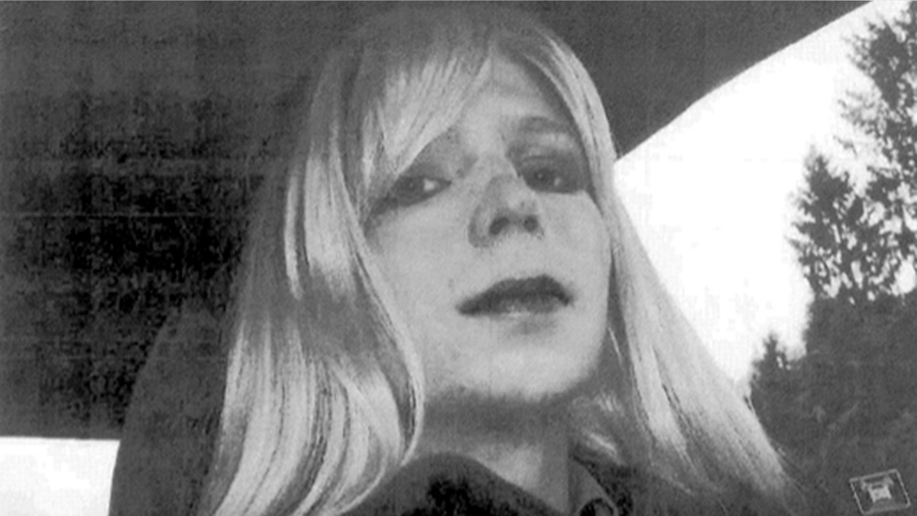FILE - In this undated file photo provided by the U.S. Army, Pfc. Chelsea Manning poses for a photo wearing a wig and lipstick.