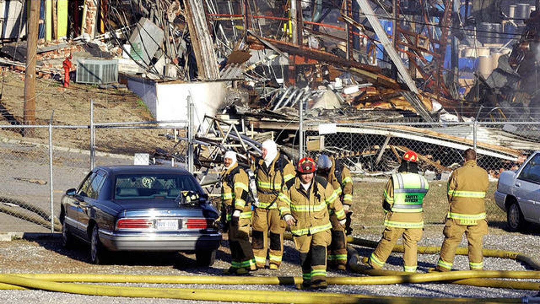 In this 2006 file photo, firefighters wait to go into a debris field at a chemical plant after an explosion and fire in Morganton, N.C.