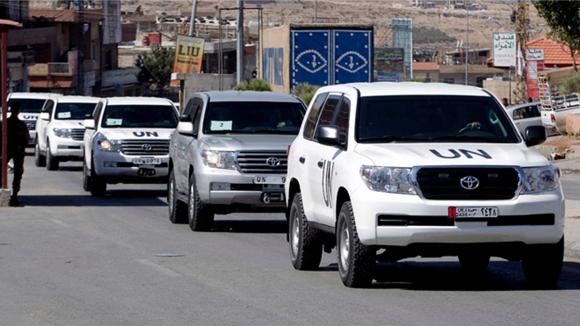 Oct. 1, 2013: A convoy of inspectors from the Organization for the Prohibition of Chemical Weapons prepares to cross into Syria at the Lebanese border crossing point of Masnaa, eastern Bekaa Valley, Lebanon. An advance group of 20 inspectors from a Netherlands-based chemical weapons watchdog arrived in Syria on Tuesday to begin their complex mission of finding, dismantling and ultimately destroying an estimated 1,000-ton chemical arsenal.