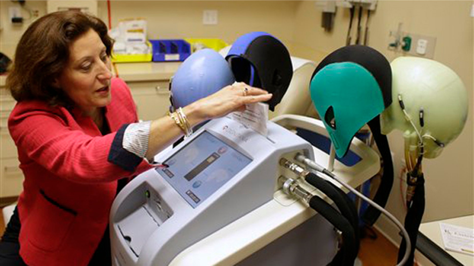 July 10, 2013: Dr. Hope Rugo, an oncologist and breast cancer specialist, demonstrates the use of a Dignitana DigniCap system at the University of California San Francisco Mount Zion Hospital cancer center in San Francisco. (AP Photo/Eric Risberg)