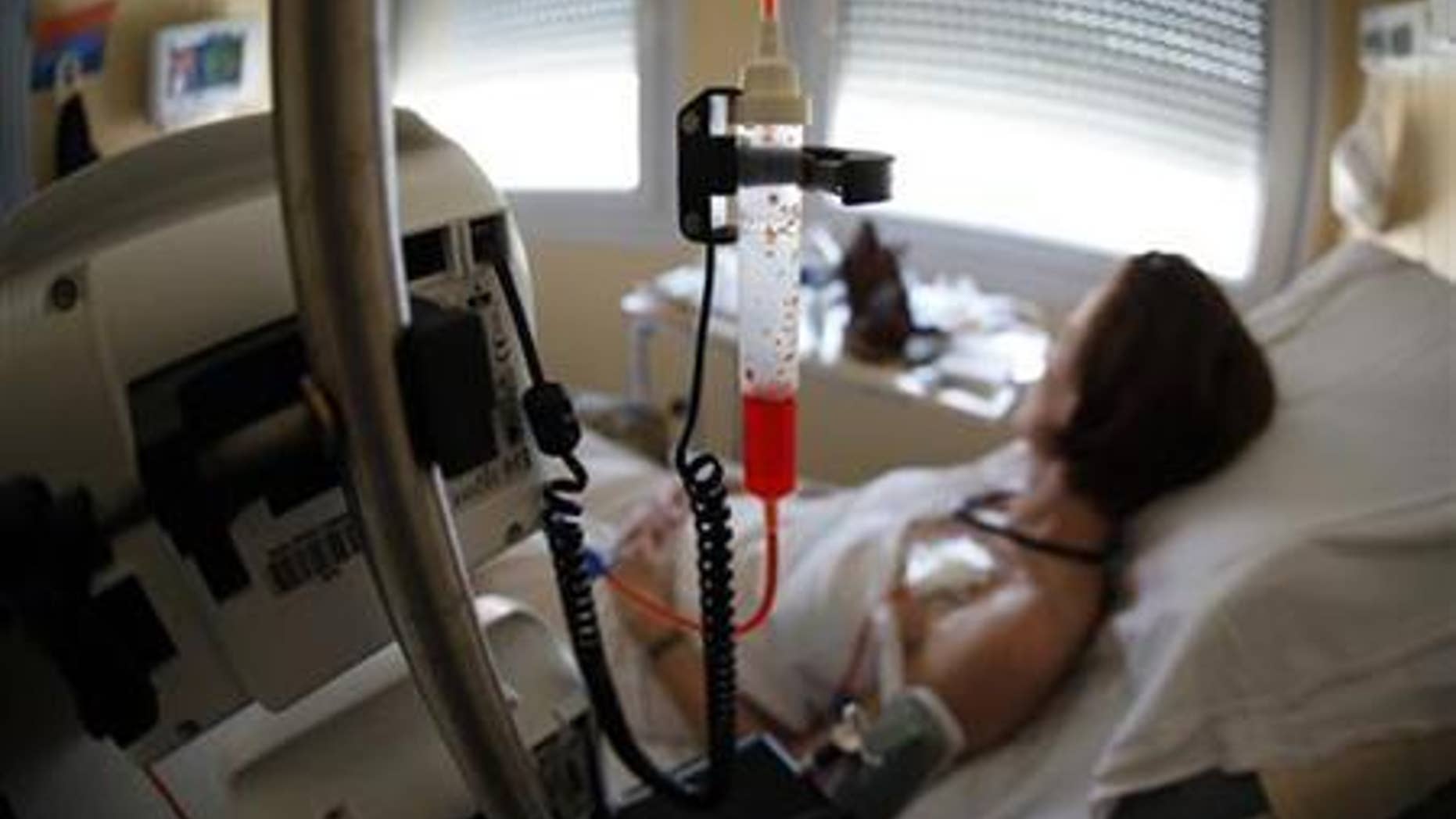 A patient receives chemotherapy treatment for breast cancer at the Antoine-Lacassagne Cancer Center in Nice July 26, 2012. REUTERS/Eric Gaillard