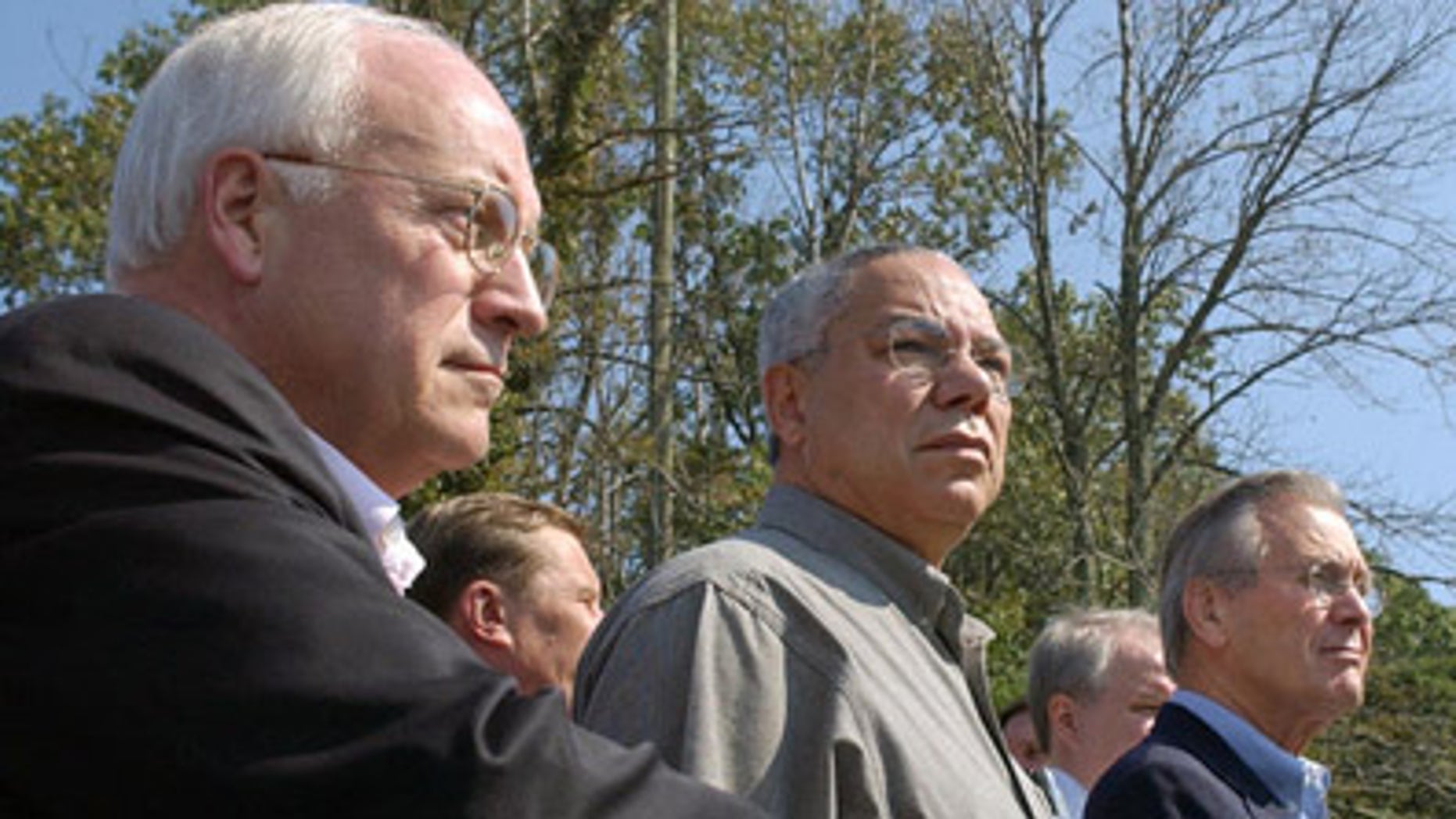 FILE: In this Sept. 27, 2003, photo, then-Vice President Dick Cheney stands with Secretary of State Colin Powell and Secretary of Defense Donald Rumsfeld at Camp David.